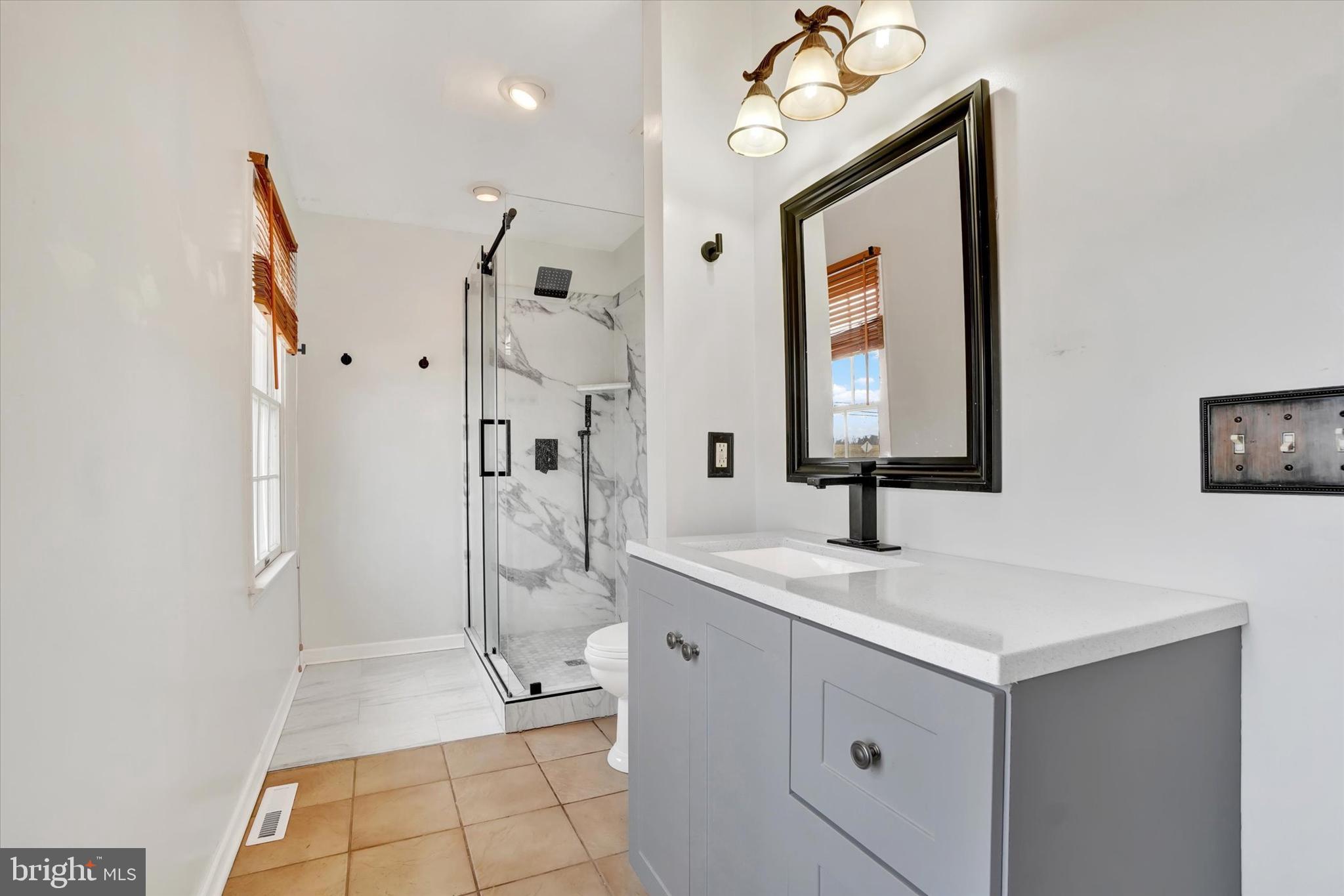 3 Harrison Road New Freedom, PA 17349 - Photo 17 of 28 a bathroom with a shower sink and mirror