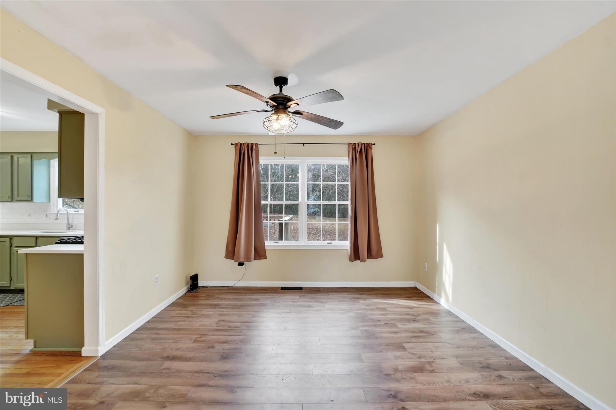 3 Harrison Road New Freedom, PA 17349 - Photo 6 of 28 a view of an empty room with a window and wooden floor