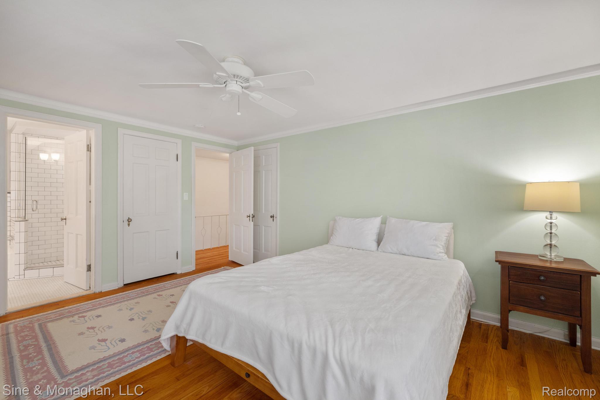 679 Neff Road Grosse Pointe, MI 48230 - Photo 21 of 78 Hardwood flooring, crown molding, ceiling fan, and white paneled doors
