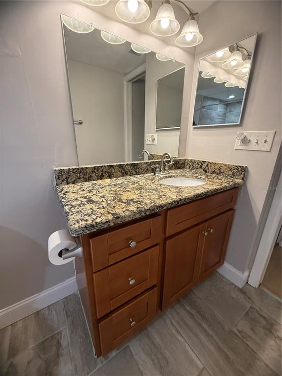208 Palmetto Court, Unit 208 Oldsmar, FL 34677 - Photo 15 of 48 a bathroom with a granite countertop sink and a mirror