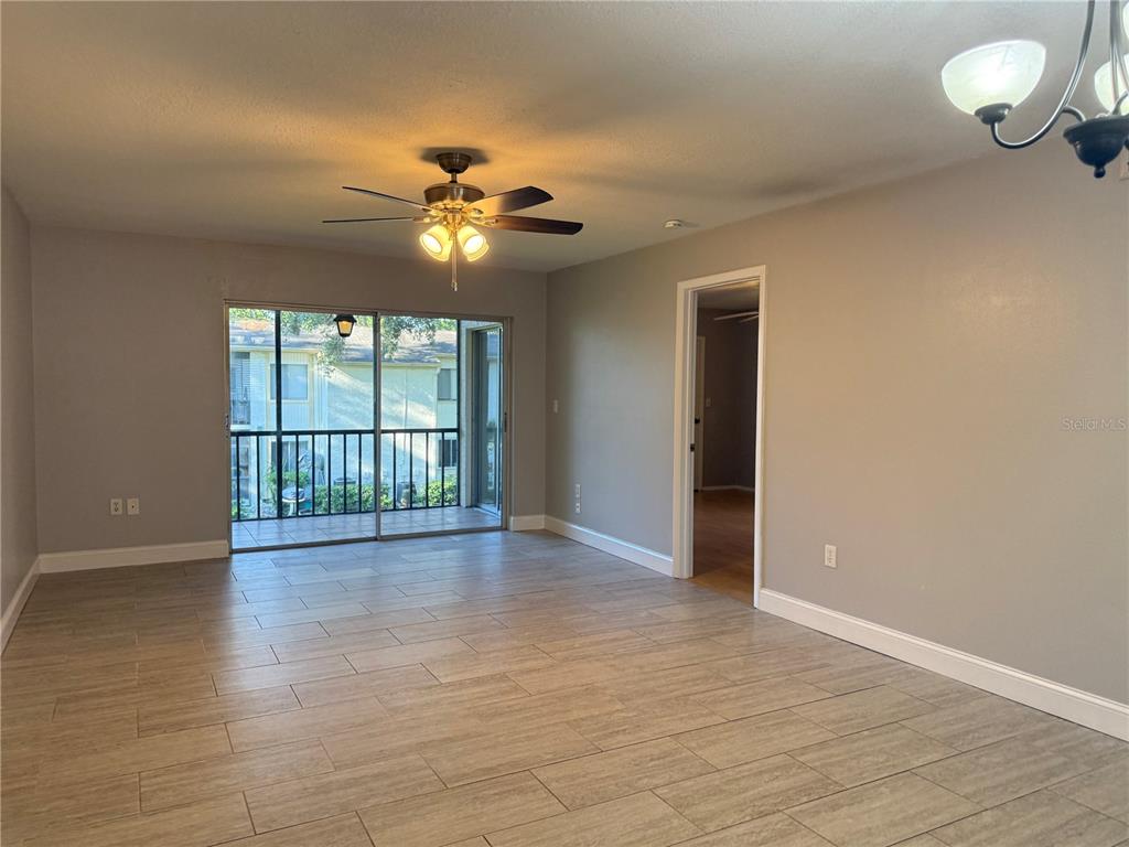 208 Palmetto Court, Unit 208 Oldsmar, FL 34677 - Photo 2 of 48 wooden floor in an empty room with a window