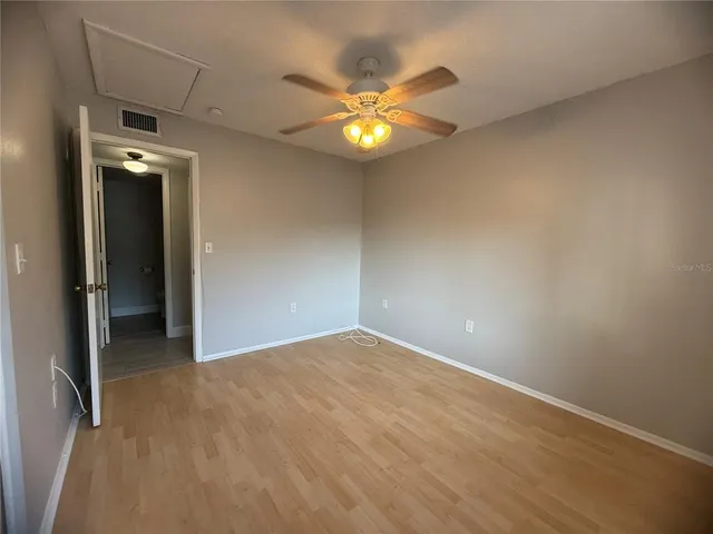a view of an empty room with a ceiling fan
