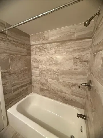 a bathroom with a shower and a bath tub