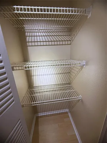 a view of swimming pool with seating area and lake view