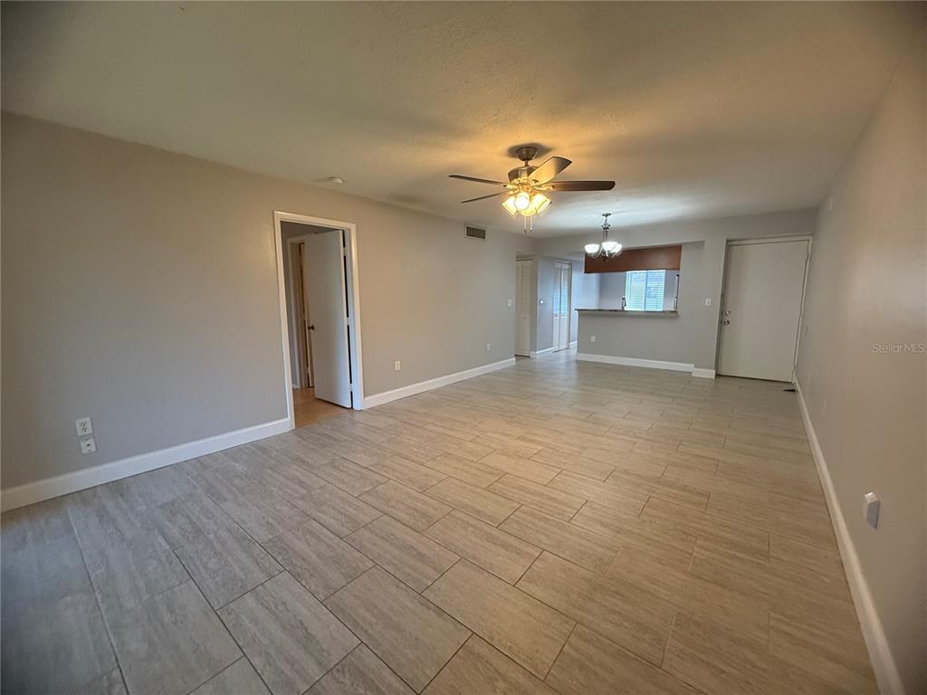 208 Palmetto Court, Unit 208 Oldsmar, FL 34677 - Photo 4 of 48 wooden floor in an empty room with a window