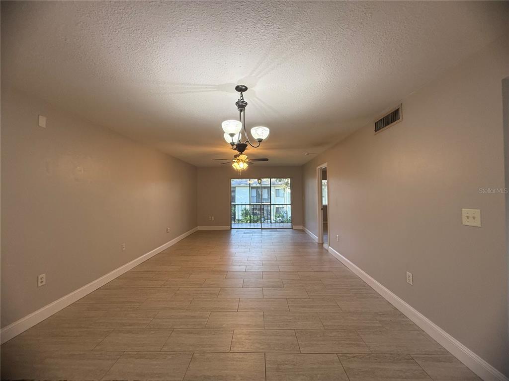 208 Palmetto Court, Unit 208 Oldsmar, FL 34677 - Photo 5 of 48 wooden floor in an empty room with a window