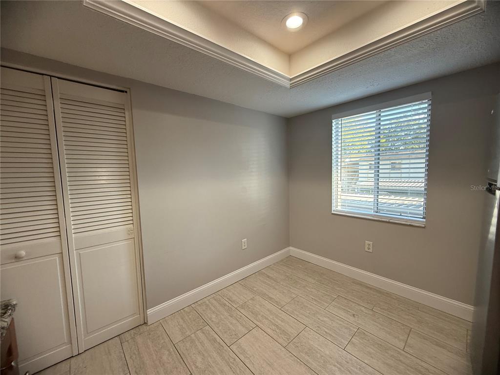 208 Palmetto Court, Unit 208 Oldsmar, FL 34677 - Photo 10 of 48 a view of empty room with wooden floor and fan