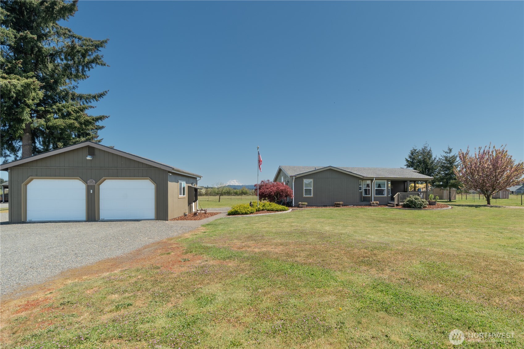 16742 Sheldon Lane Southwest Rochester, WA 98579 - Photo 2 of 40 a big house with a big yard and large trees