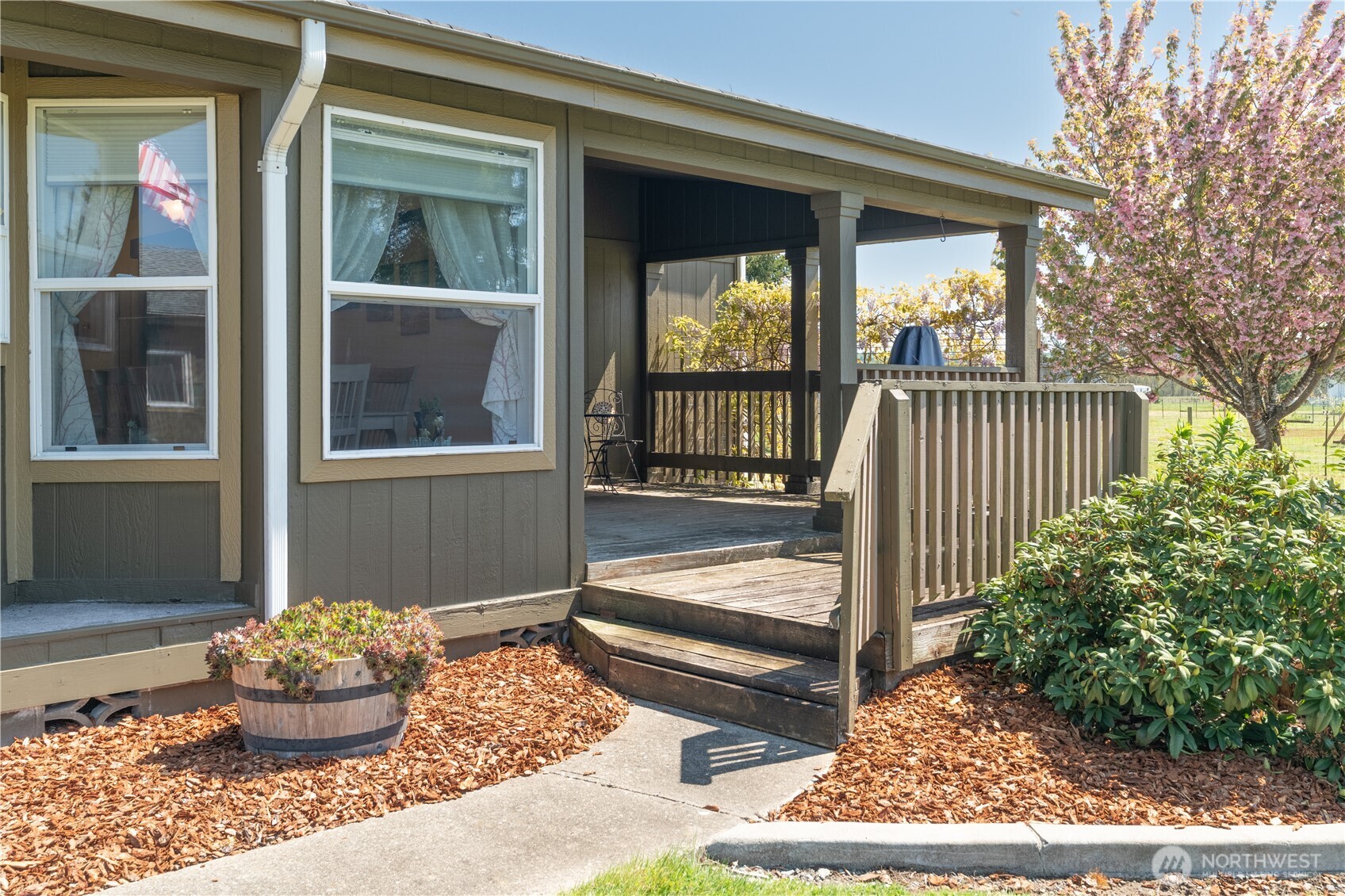 16742 Sheldon Lane Southwest Rochester, WA 98579 - Photo 3 of 40 a porch with a bench and potted plants