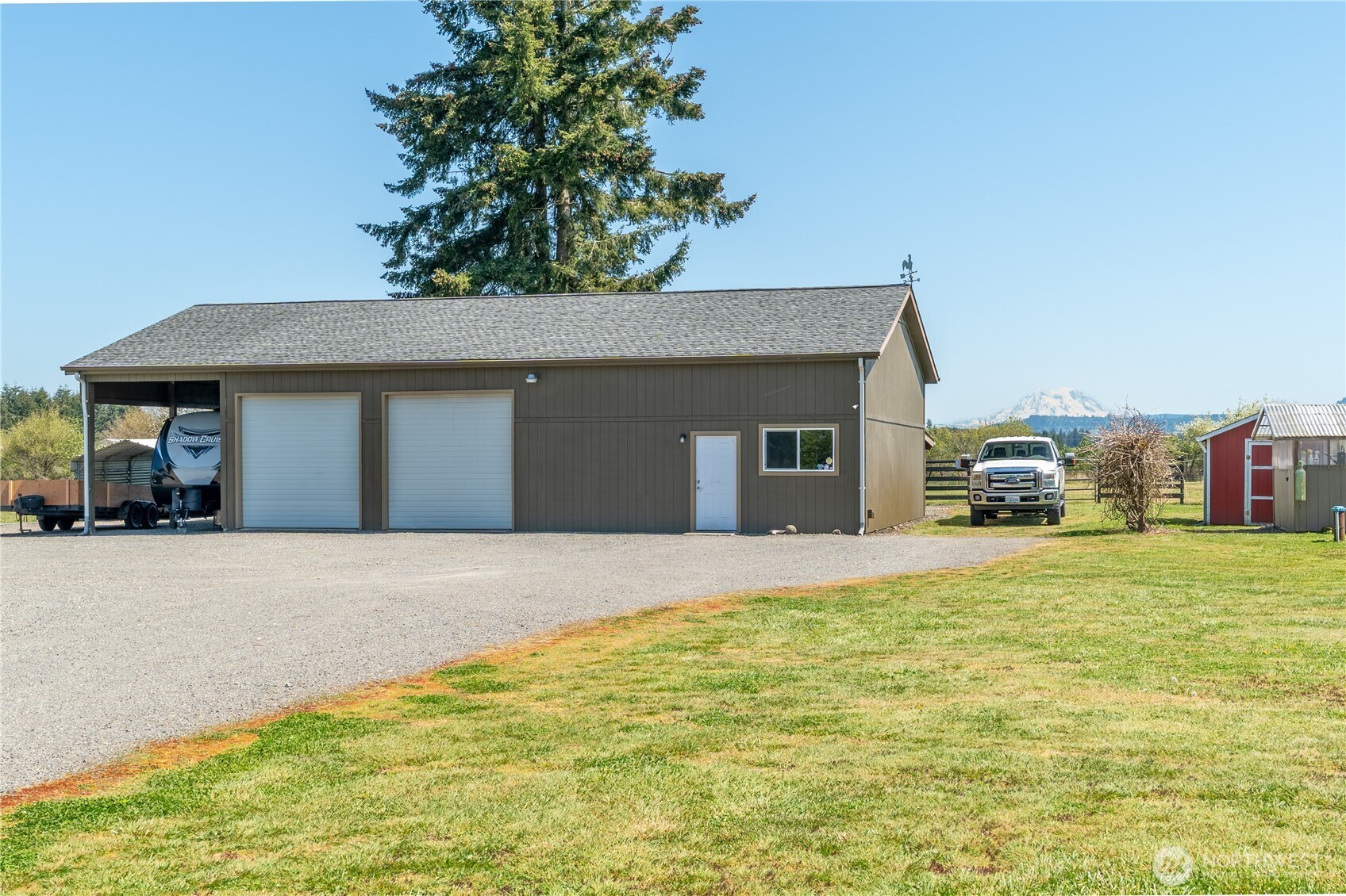 16742 Sheldon Lane Southwest Rochester, WA 98579 - Photo 37 of 40 a front view of a house with a garden and parking