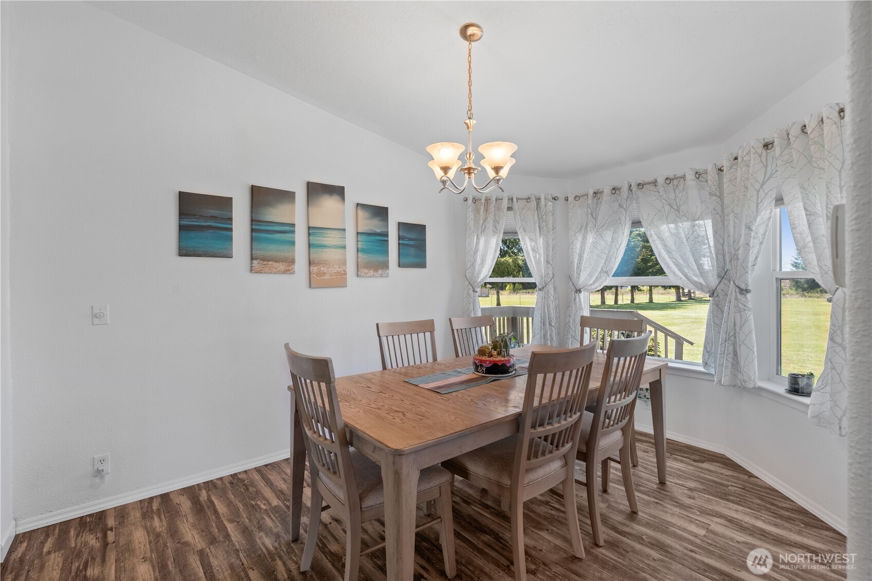 16742 Sheldon Lane Southwest Rochester, WA 98579 - Photo 7 of 40 a view of a dining room with furniture and chandelier