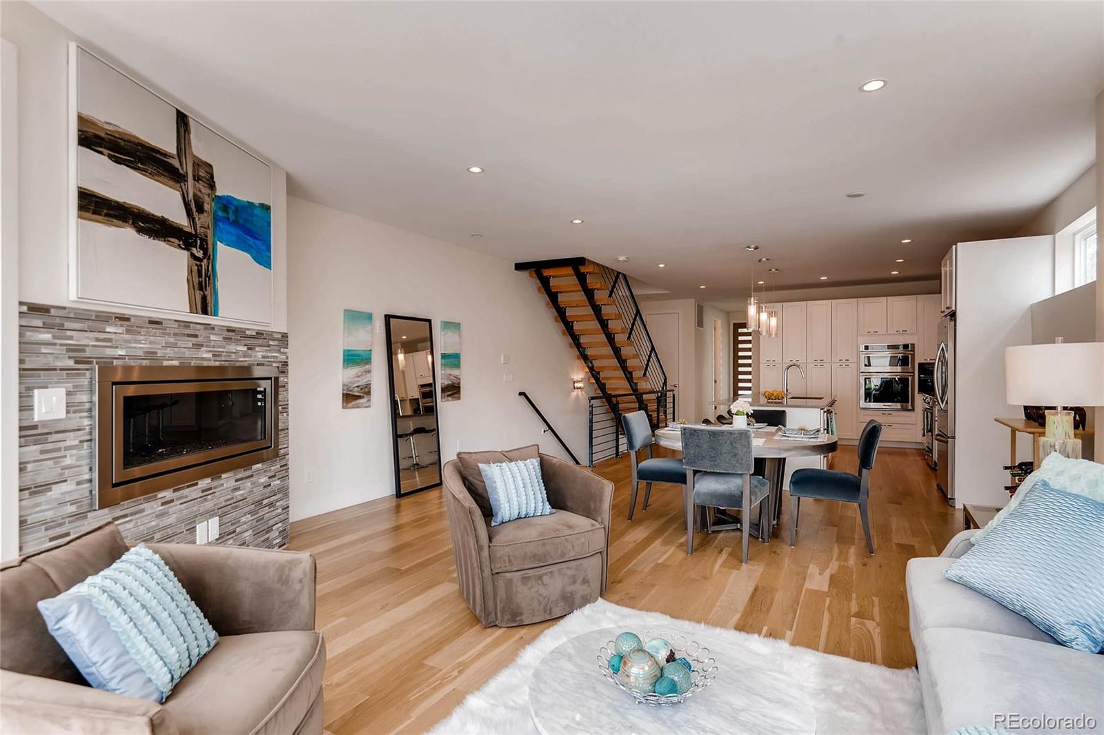 3957 Utica Street Denver, CO 80212 - Photo 4 of 28 a living room with furniture a fireplace and a flat screen tv