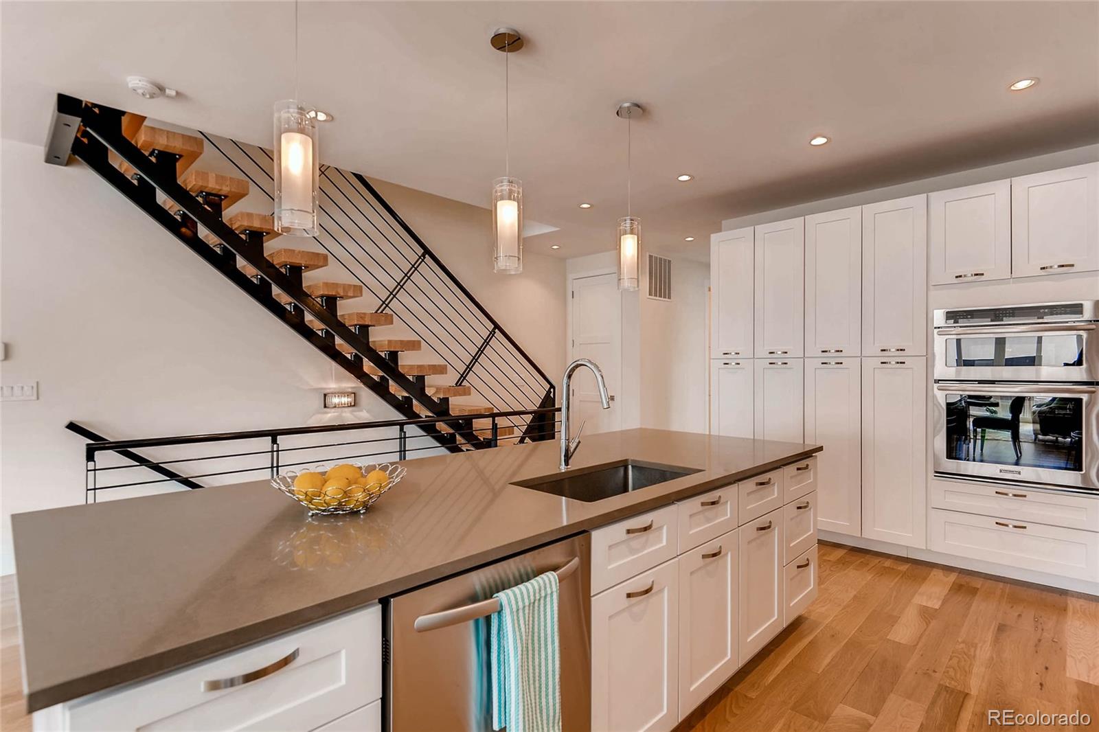 3957 Utica Street Denver, CO 80212 - Photo 8 of 28 a kitchen with white cabinets and appliances