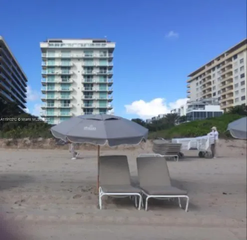 a view of a chairs and table in the back yard