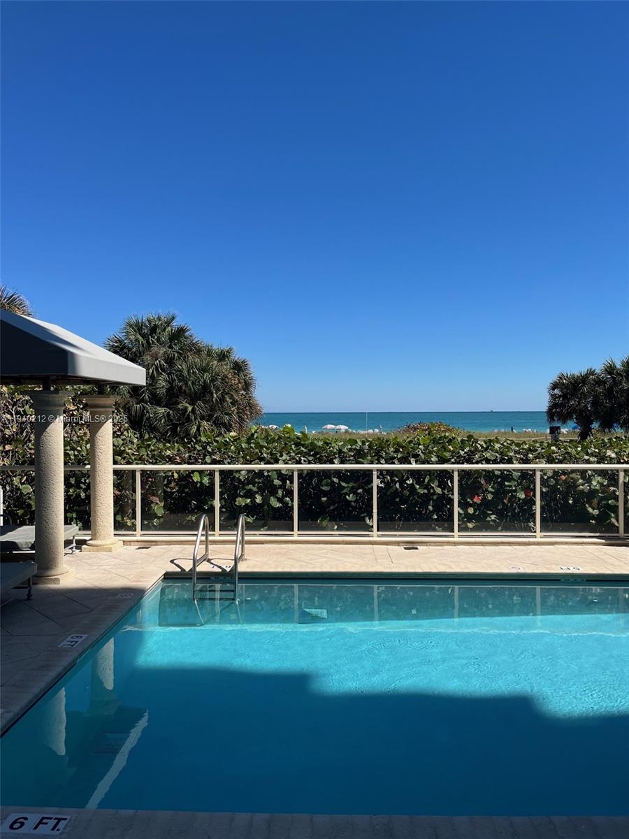 9499 Collins Avenue, Unit 308 Surfside, FL 33154 - Photo 5 of 8 a view of a swimming pool with an outdoor seating
