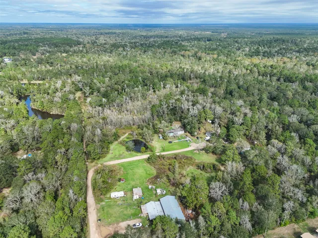 a view of a green field with lots of bushes