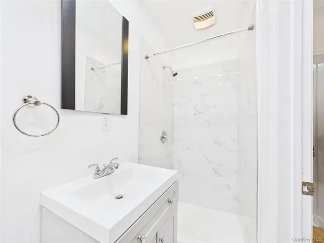 a bathroom with a sink vanity and a mirror