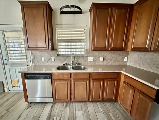 a kitchen with granite countertop wooden floors and sink