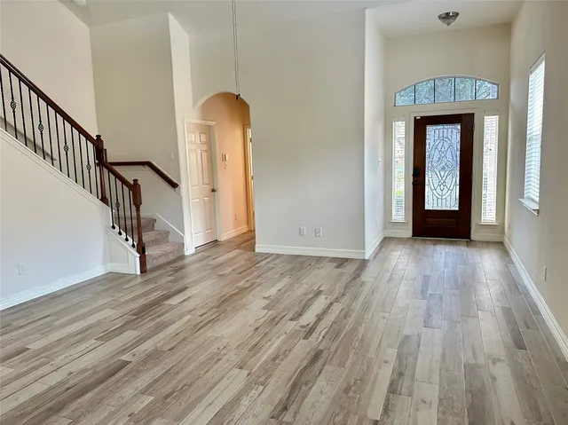 a view of an entryway with wooden floor