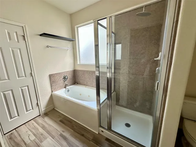 a bathroom with a bathtub and a shower