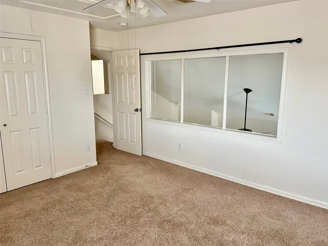 an empty room with sliding glass door and shower