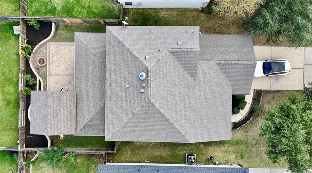 an aerial view of a house with a yard and fence