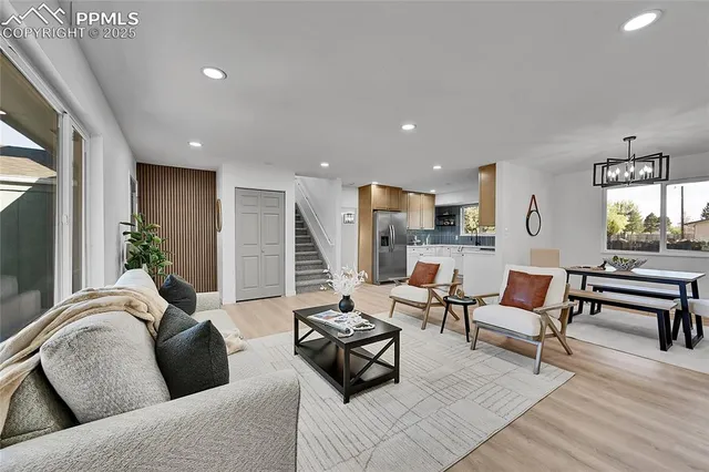a living room with furniture and wooden floor
