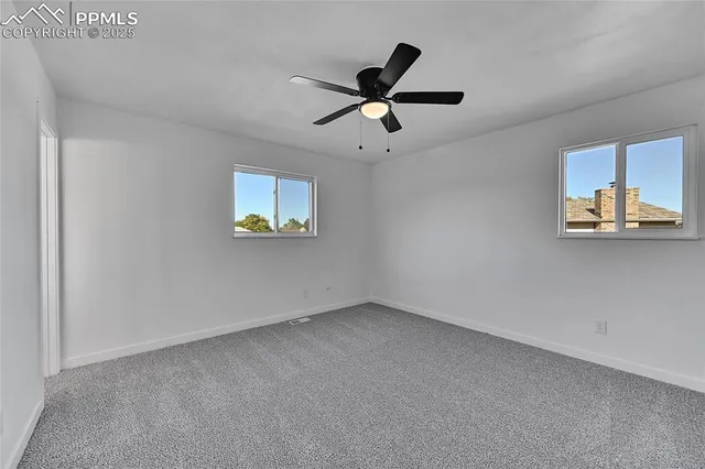 a view of a ceiling fan and a window