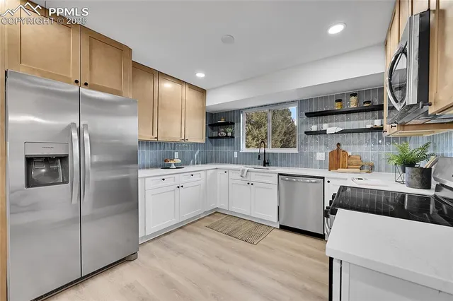 a kitchen with cabinets and stainless steel appliances