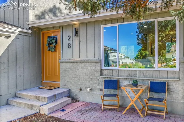 a backyard of a house with table and chairs