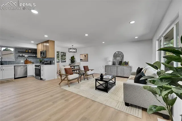 a living room with furniture and kitchen view