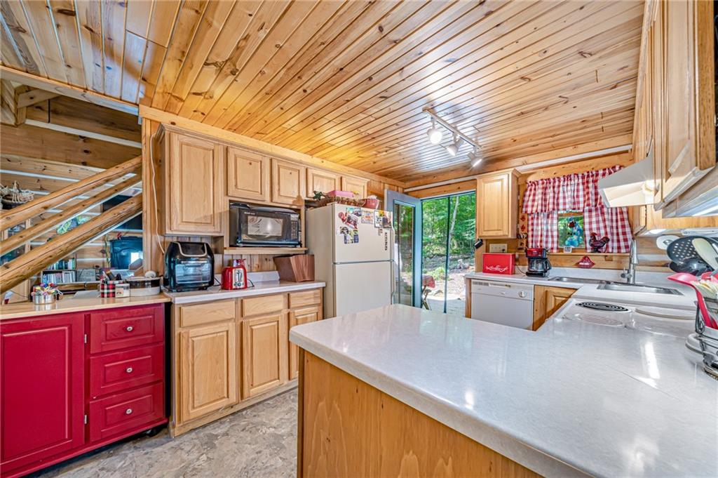 183 Chestnut Ridge Road Acme, PA 15610 - Photo 11 of 29 a kitchen with stainless steel appliances wooden cabinets and a stove