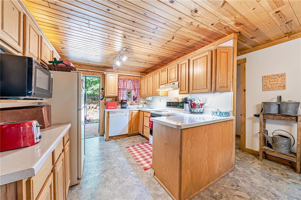 183 Chestnut Ridge Road Acme, PA 15610 - Photo 12 of 29 a kitchen with granite countertop a sink a counter space appliances and cabinets