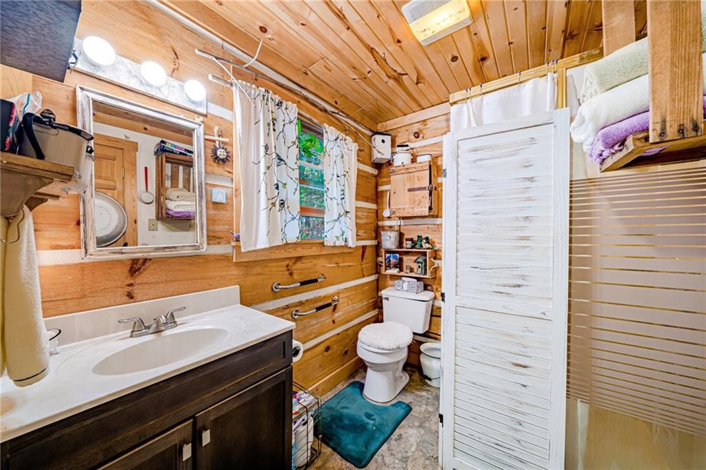 183 Chestnut Ridge Road Acme, PA 15610 - Photo 15 of 29 a bathroom with a sink a toilet and shower curtain