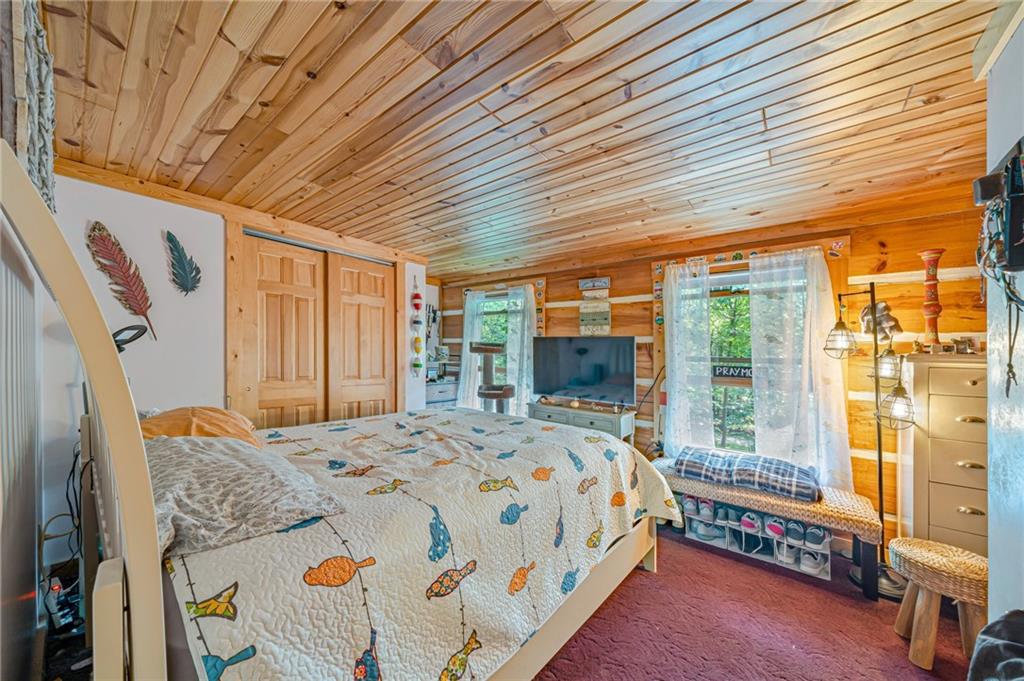 183 Chestnut Ridge Road Acme, PA 15610 - Photo 21 of 29 a bedroom with a bed and large windows
