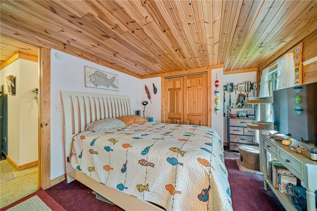 183 Chestnut Ridge Road Acme, PA 15610 - Photo 22 of 29 a bedroom with a bed and wooden floor
