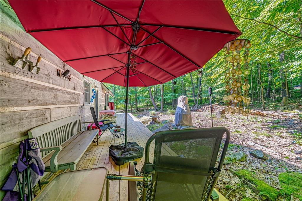 183 Chestnut Ridge Road Acme, PA 15610 - Photo 26 of 29 an outdoor sitting area with furniture and umbrella