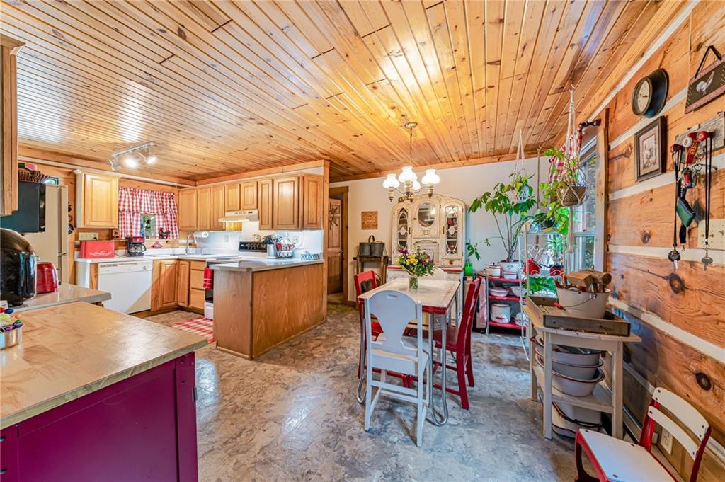 183 Chestnut Ridge Road Acme, PA 15610 - Photo 8 of 29 a kitchen with stainless steel appliances kitchen island granite countertop a table chairs and a refrigerator
