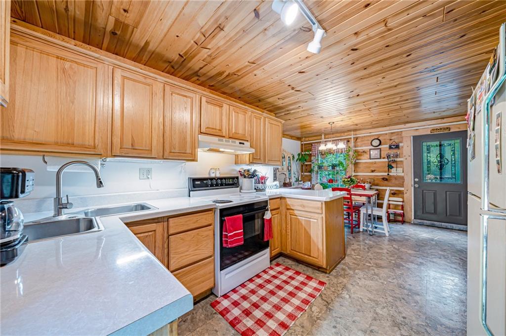 183 Chestnut Ridge Road Acme, PA 15610 - Photo 9 of 29 a kitchen with a sink a stove and cabinets