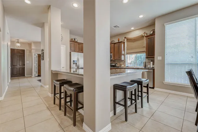 a view of kitchen with dining area and windows