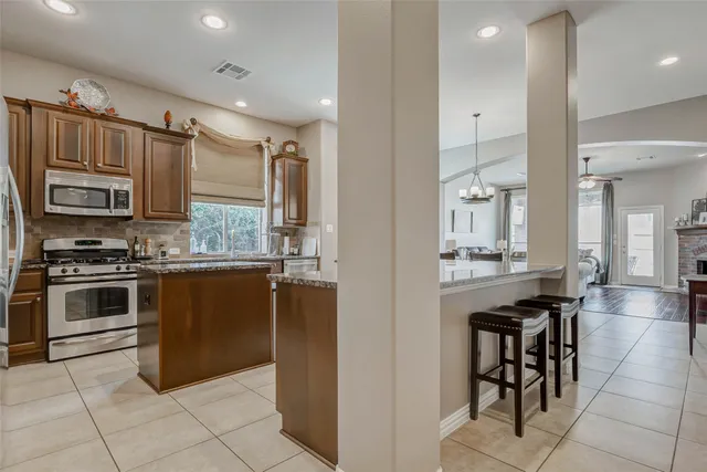 a kitchen with a sink cabinets and stainless steel appliances
