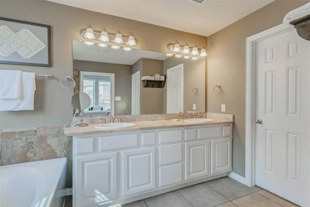 a bathroom with a double vanity sink and a mirror