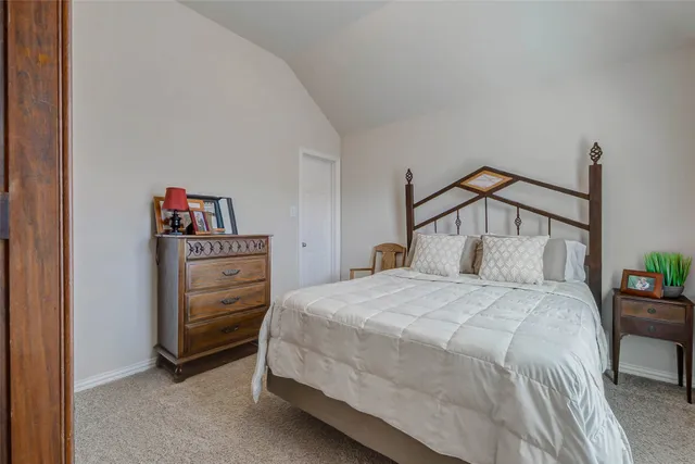 a bedroom with a bed and cabinets