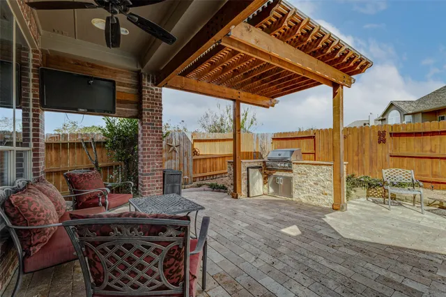 a patio with glass top table and chairs