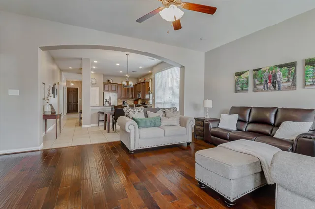 a living room with furniture and a wooden floor