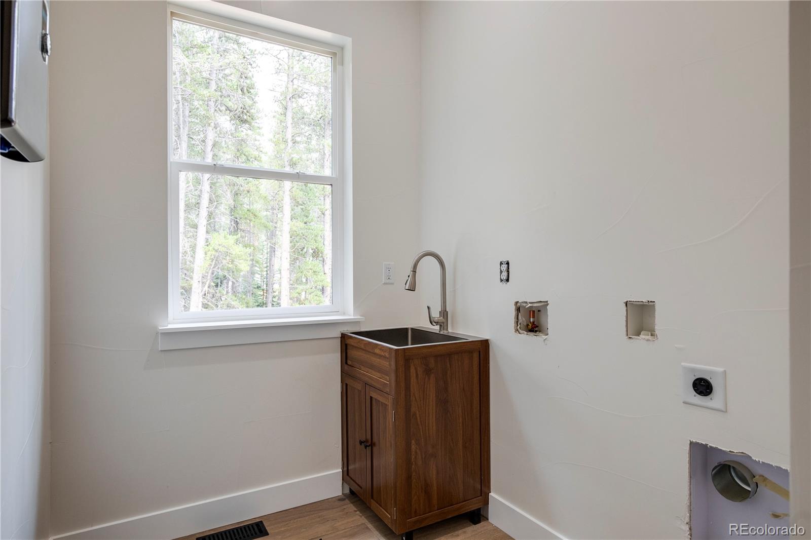 146 Elk Road Idaho Springs, CO 80452 - Photo 12 of 15 a room with a window a sink and a mirror