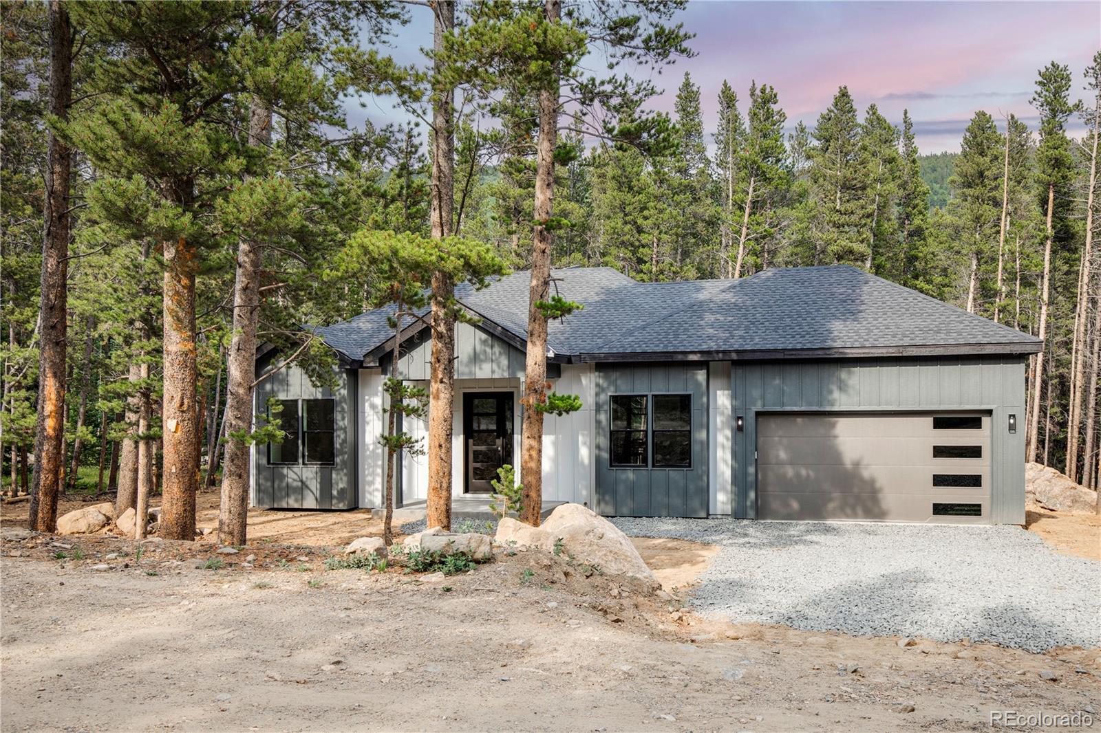 146 Elk Road Idaho Springs, CO 80452 - Photo 2 of 15 a front view of a house with a yard and garage