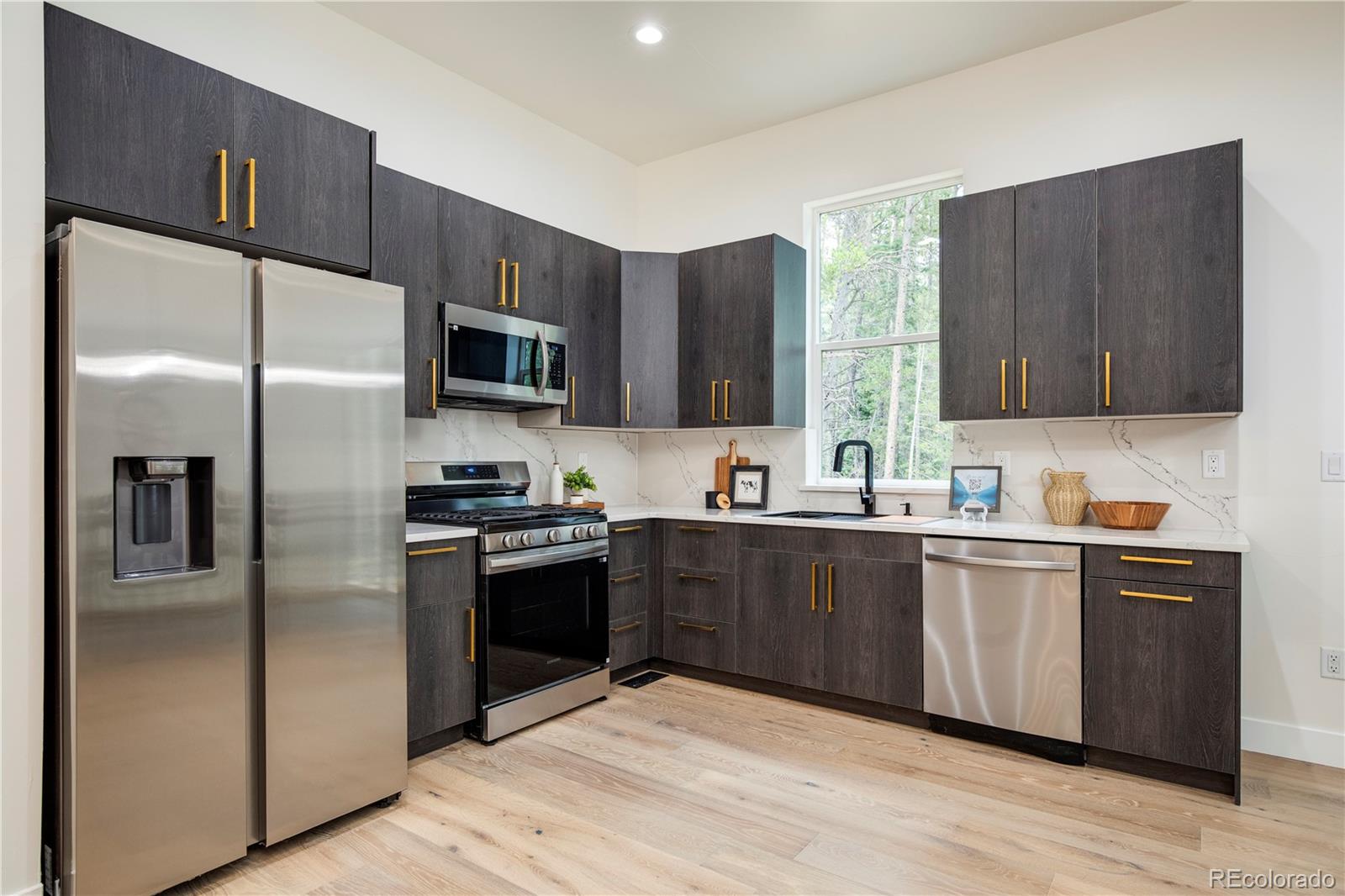 146 Elk Road Idaho Springs, CO 80452 - Photo 5 of 15 a kitchen with stainless steel appliances granite countertop a refrigerator stove top oven and sink