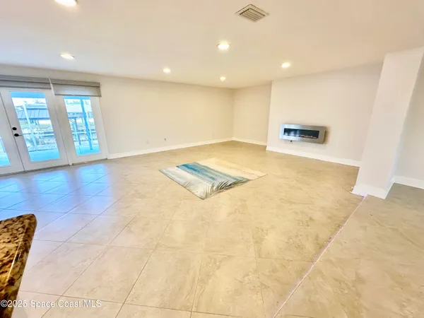 a view of a hallway with bathroom and a tub