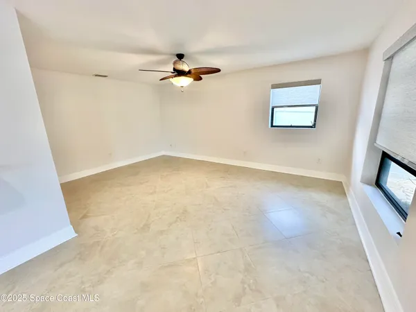 a large white kitchen with a sink and a large window